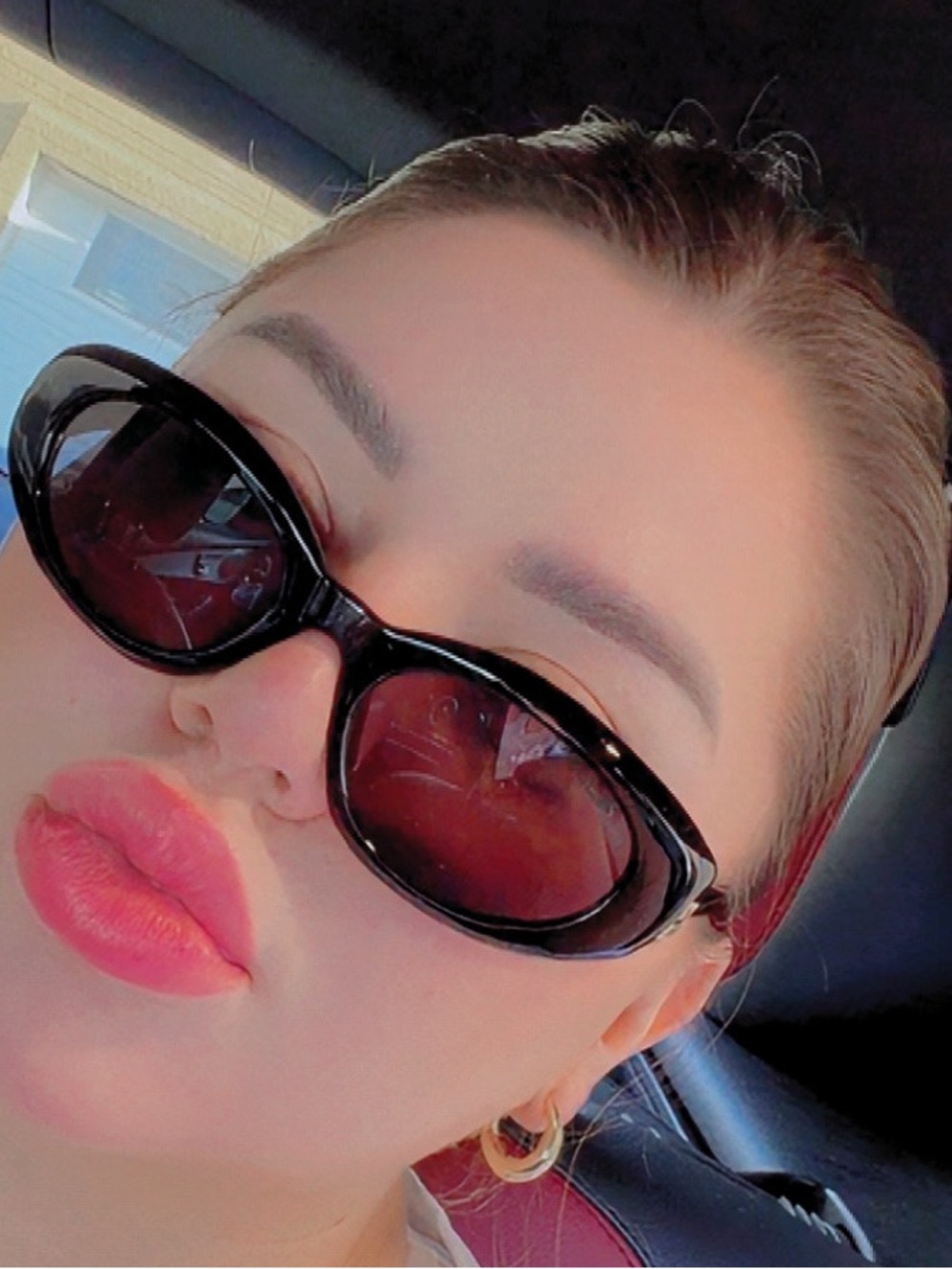 Miu Miu Black Oval Sunglasses with Brown-Tinted Lenses